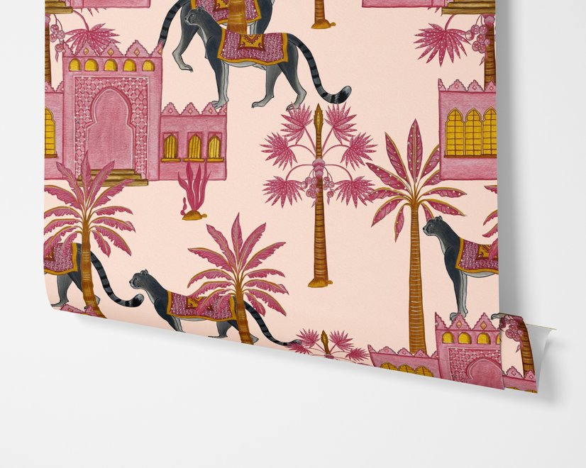 Tropical foliage wallpaper with black panthers, pink palace facades and ochre palms on pale peach