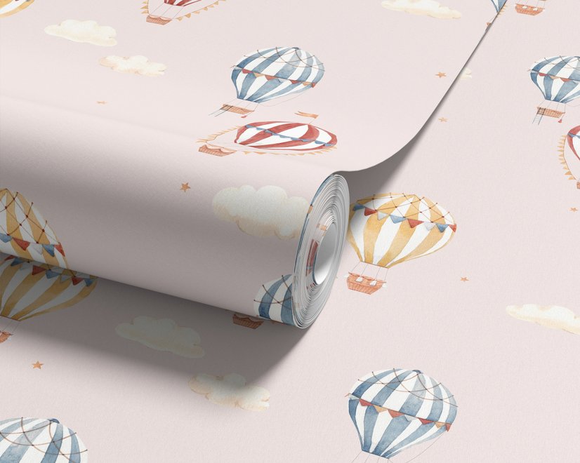 Hot air balloon nursery room wallpaper with watercolour balloons, clouds and stars on a soft blush-pink ground