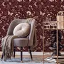 Pink butterflies wallpaper on a claret ground with cream flowers, moons, stars and spotted mushrooms.