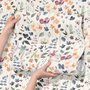 Watercolour floral wallpaper repeat with navy, blue, blush and peach wildflowers on warm cream