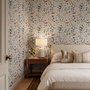 Watercolour floral wallpaper repeat with navy, blue, blush and peach wildflowers on warm cream