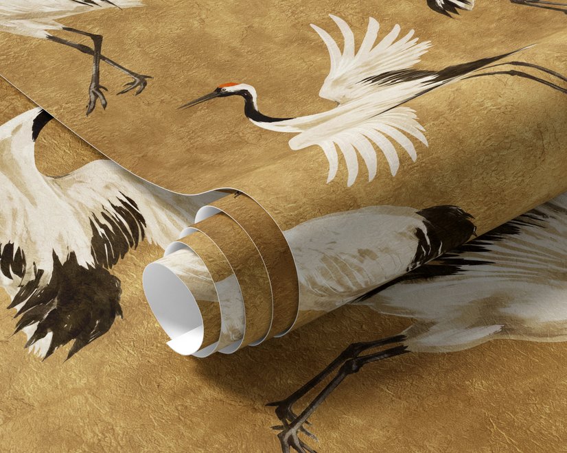 Japanese crane wallpaper with white, black and red cranes in flight on an antique-gold textured ground