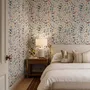 Watercolour floral wallpaper repeat with navy, blue, blush and peach wildflowers on warm cream