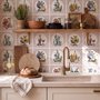 Bar wallpaper with cream tile grid, dusty rose arches, illustrated wine bottles, fruit and café still lifes