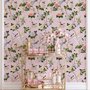 Cute pink wallpaper with birds, tan branches, green leaves and ivory, coral and lilac flowers.