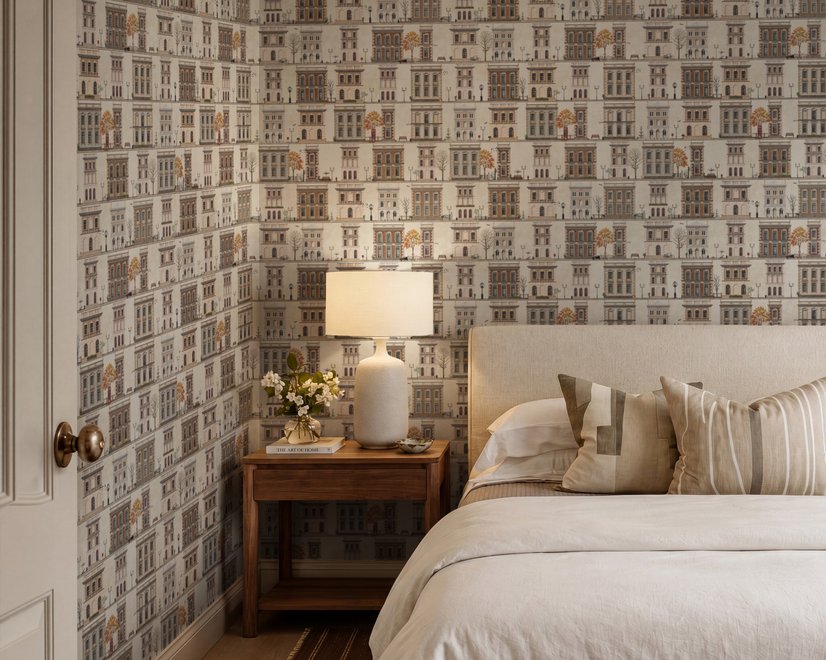 Vintage city wallpaper with illustrated European townhouses, lamps, bicycles, benches and orange-gold trees