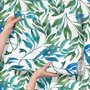 Dark olive green wallpaper with teal and cobalt watercolour lance leaves on a white ground