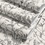Black outline botanical wallpaper with charcoal wildflowers and grasses on a warm ivory cream ground