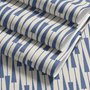 Cream colored wallpaper with denim blue geometric totem stripe repeat on a linen texture ground
