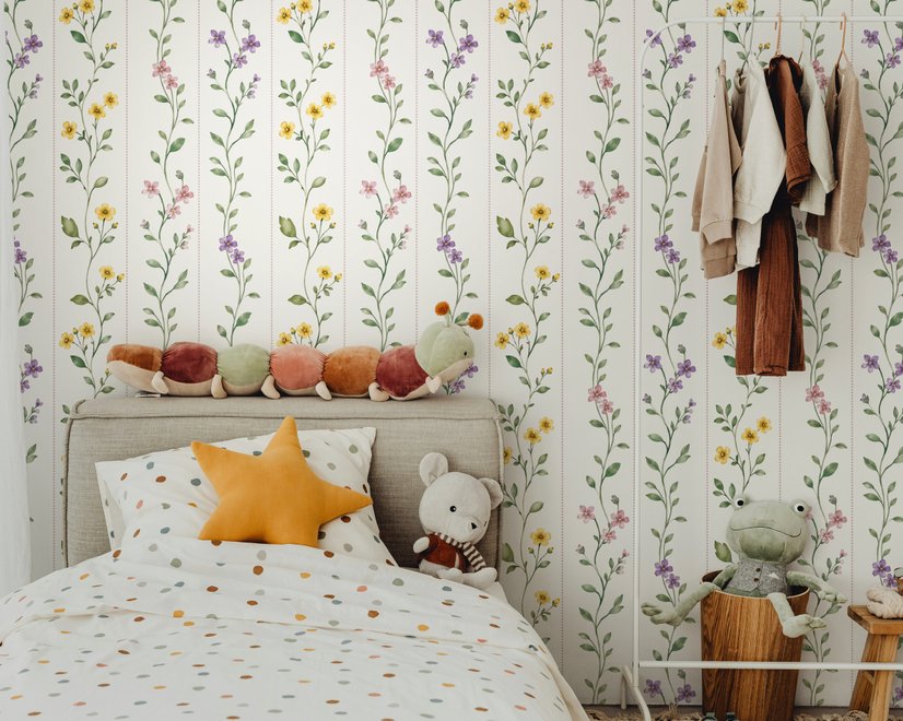 Cute floral wallpaper with green vine trails and pink, purple and yellow watercolor flowers on cream