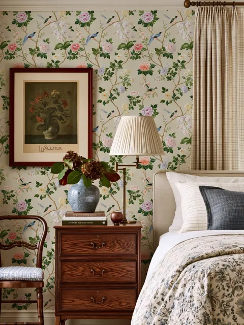 Chinoiserie wallpaper with blue-grey birds, pink peonies, white orchids and green branches on ivory-cream ground