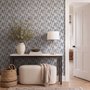Cream colored wallpaper with denim blue geometric totem stripe repeat on a linen texture ground