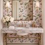 Cute pink wallpaper with birds, tan branches, green leaves and ivory, coral and lilac flowers.