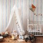 Blue and light blue wallpaper with hand-painted vertical watercolour stripes on a clean white ground