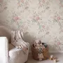 Pink chinoiserie wallpaper with watercolor flowers, blue-grey leaves and red berries on a cream linen-texture ground