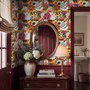 Floral and fish wallpaper with coral blooms, teal fish and black white flowers on metallic mustard-gold ground