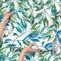 Dark olive green wallpaper with teal and cobalt watercolour lance leaves on a white ground