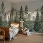 Misty mountain wallpaper mural with tall pine trees, layered green forest and pale foggy ridges