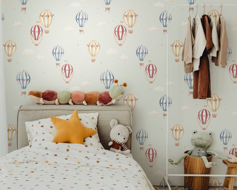 Watercolor blue wallpaper with hot air balloons, cream clouds and peach stars on pale sage green