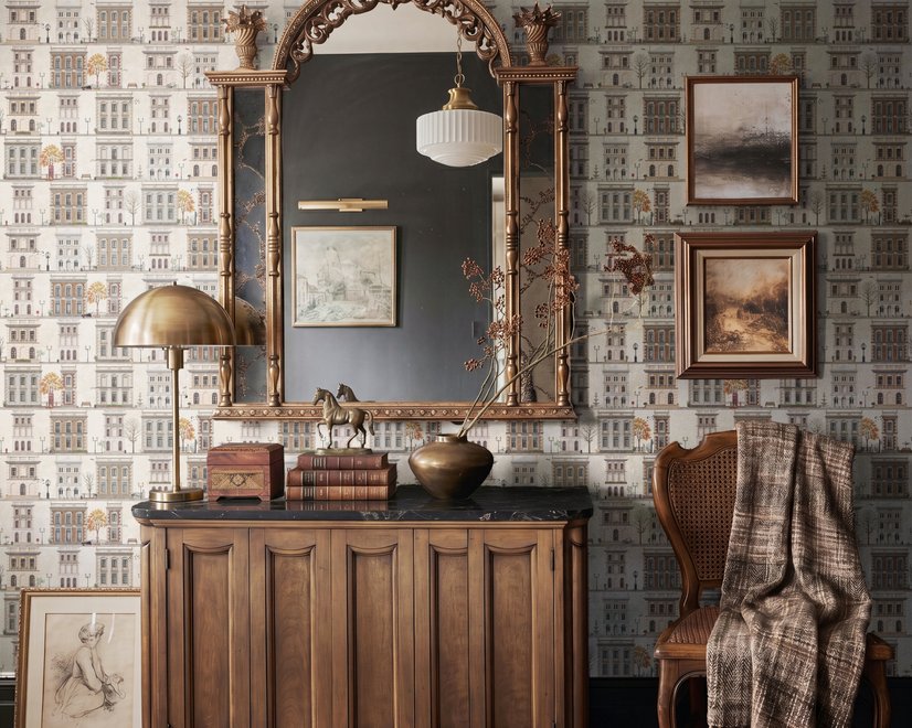Vintage city wallpaper with illustrated European townhouses, lamps, bicycles, benches and orange-gold trees