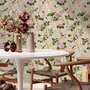 Chinoiserie wallpaper with blue-grey birds, pink peonies, white orchids and green branches on ivory-cream ground