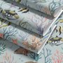 Modern coastal wallpaper with watercolour tropical fish, coral, seaweed, shells and bubbles on light aqua-blue