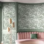 Sage green botanical floral wallpaper with white poppy flowers, lobed leaves and dotted seed centres