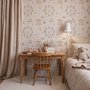 Children's playroom wallpaper with pastel Ferris wheel, carousel horses, tents and balloons on blush pink