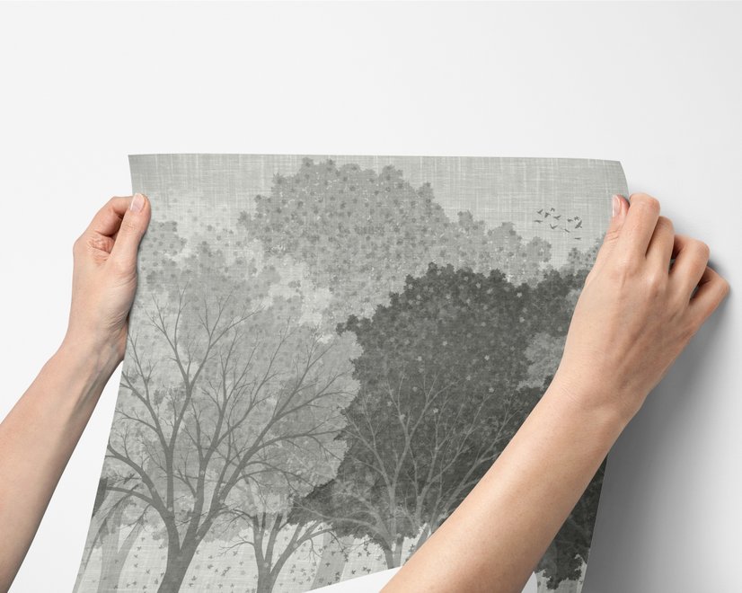 Light gray wallpaper mural with layered ink-wash woodland trees, falling leaves and birds