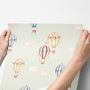 Watercolor blue wallpaper with hot air balloons, cream clouds and peach stars on pale sage green