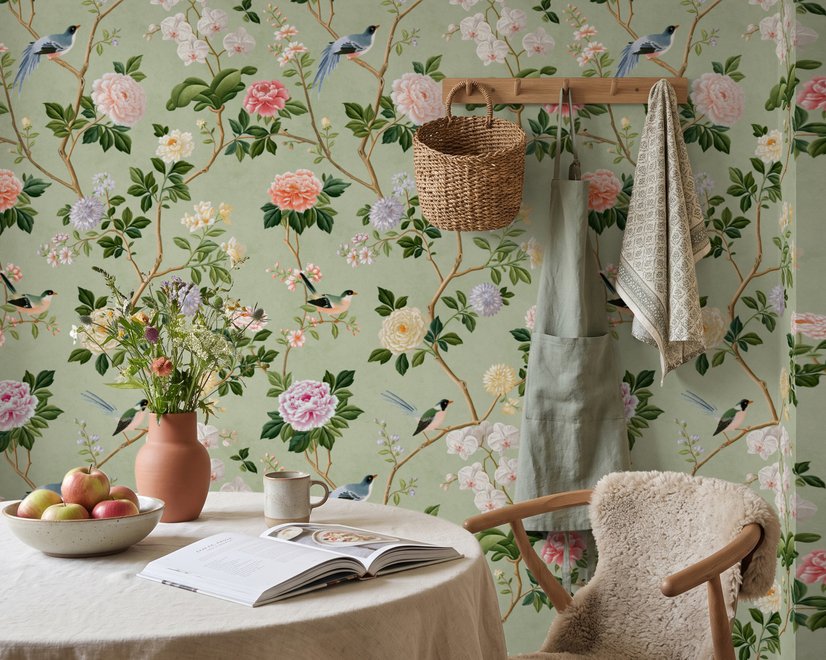 Celadon-sage chinoiserie wallpaper with blue-grey birds, tan branches, pink peonies and white orchids