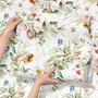 Watercolour floral wallpaper with sage leaves, blush and ochre flowers on a white ground