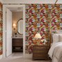 Floral and fish wallpaper with coral blooms, teal fish and black white flowers on metallic mustard-gold ground