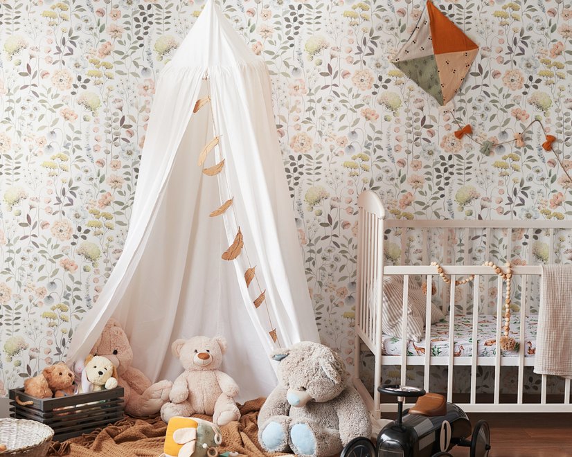Watercolour wildflower wallpaper with pastel flowers and sage leaves on a white ground