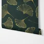 Dark green wallpaper with metallic antique-gold etched ginkgo leaves on a textured forest-green teal ground