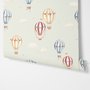 Watercolor blue wallpaper with hot air balloons, cream clouds and peach stars on pale sage green