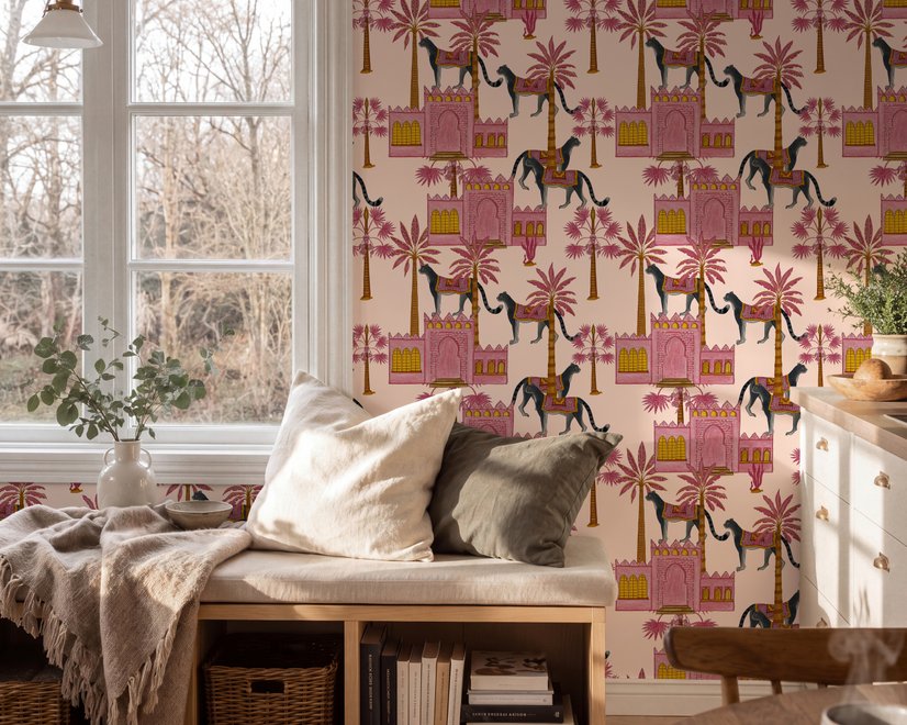 Tropical foliage wallpaper with black panthers, pink palace facades and ochre palms on pale peach