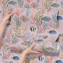 Cute pink seashell wallpaper with watercolour reef fish, coral, seaweed, starfish and shells on blush pink