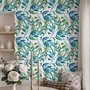 Dark olive green wallpaper with teal and cobalt watercolour lance leaves on a white ground