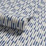 Cream colored wallpaper with denim blue geometric totem stripe repeat on a linen texture ground