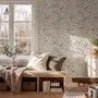 Black outline botanical wallpaper with charcoal wildflowers and grasses on a warm ivory cream ground