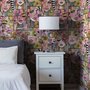 Bold wallpaper for powder room with pop art female faces, pink flowers, black comic panels, mustard, teal and fuchsia details