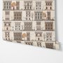 Vintage city wallpaper with illustrated European townhouses, lamps, bicycles, benches and orange-gold trees