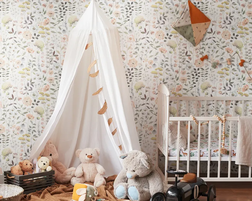 Watercolour wildflower wallpaper with pastel flowers and sage leaves on a white ground