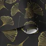 Black wallpaper with antique metallic gold ginkgo leaves on a mottled charcoal ground