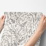 Black outline botanical wallpaper with charcoal wildflowers and grasses on a warm ivory cream ground