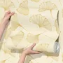 Ginkgo leaf wallpaper with ochre-gold linework on warm ivory and cream parchment ground