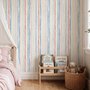 Blue and light blue wallpaper with hand-painted vertical watercolour stripes on a clean white ground