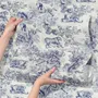 Jungle wallpaper with animals in navy toile, showing tigers, elephants and monkeys on an ivory cream ground