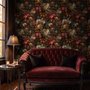 Dark moody floral wallpaper with cream peonies, coral lilies, berries and green foliage on chocolate brown